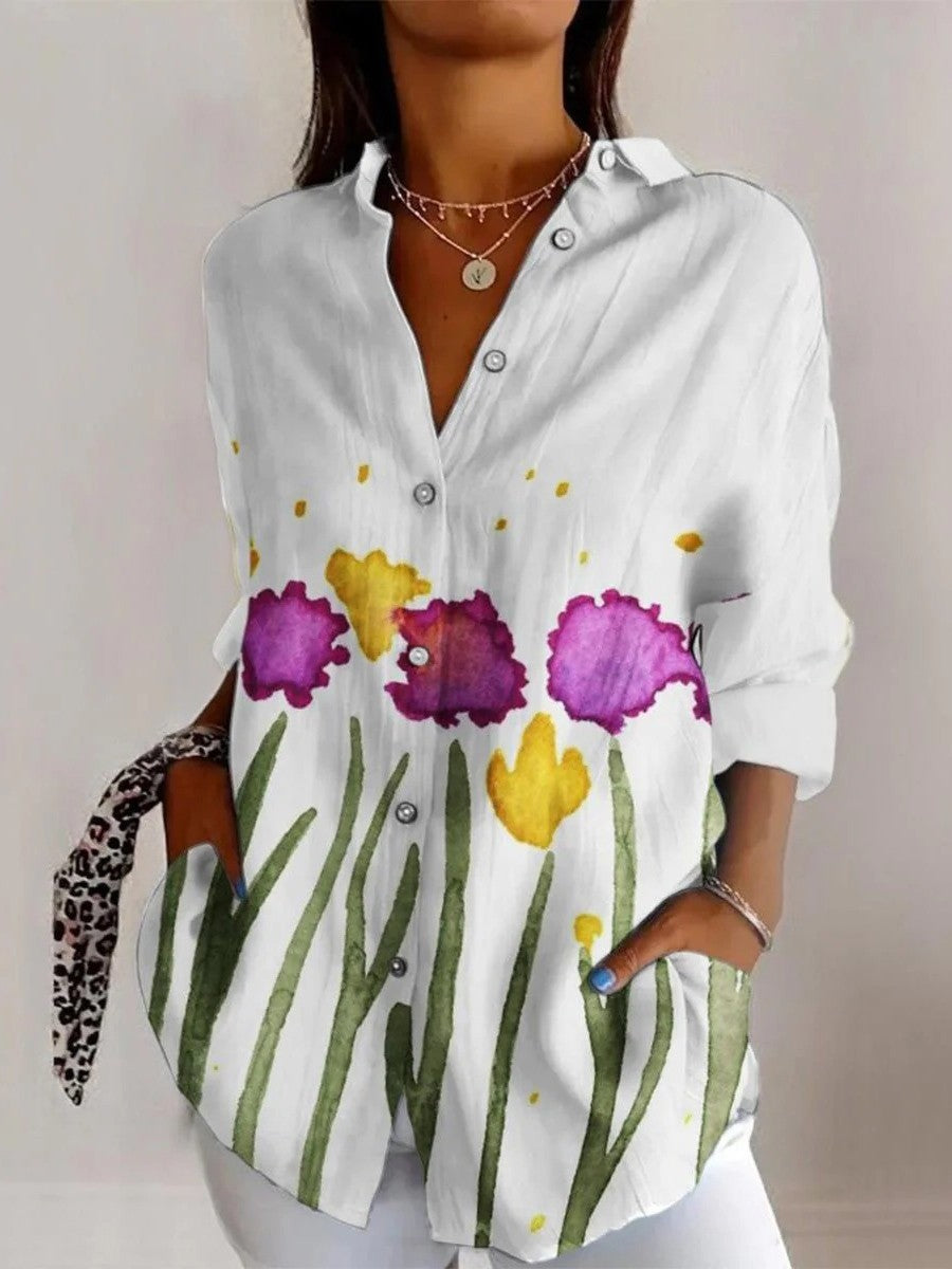 Camicetta elegante con stampa floreale e scollatura a punta: una combinazione perfetta di stile e raffinatezza.