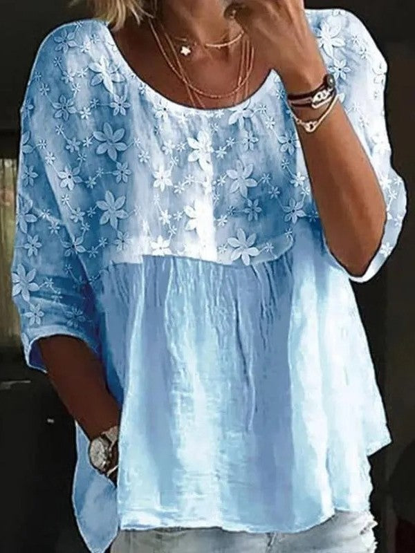 Elegante blusa da donna in cotone con vistose rientranze e applicazioni floreali, colletto classico e maniche lunghe