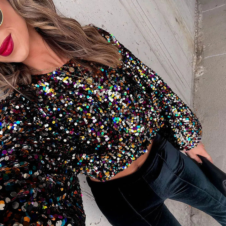 Top alla moda con paillettes e eleganti maniche a buffet