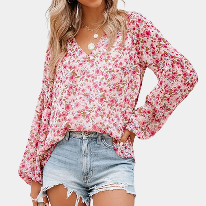 Elegante blusa femminile in delicato chiffon con motivo floreale ed elegante scollatura a punta