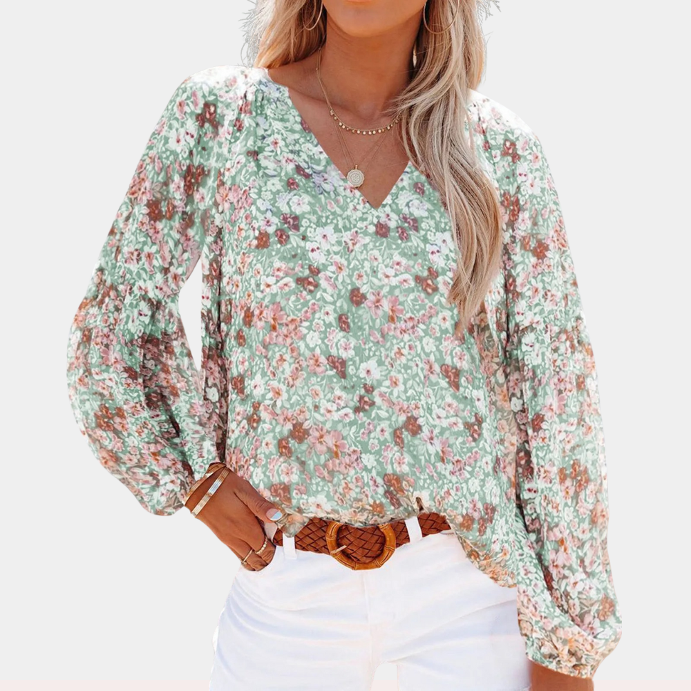 Elegante blusa femminile in delicato chiffon con motivo floreale ed elegante scollatura a punta