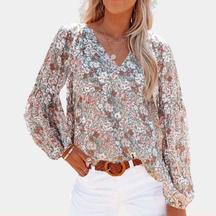 Elegante blusa femminile in delicato chiffon con motivo floreale ed elegante scollatura a punta