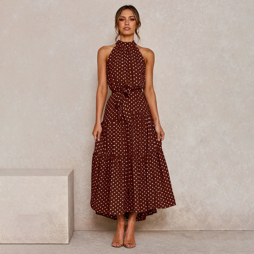 Elegante accappatoio da donna con collo a farfalla in fantasia pois, realizzato in morbido jersey con molte pratiche tasche e senza polsini